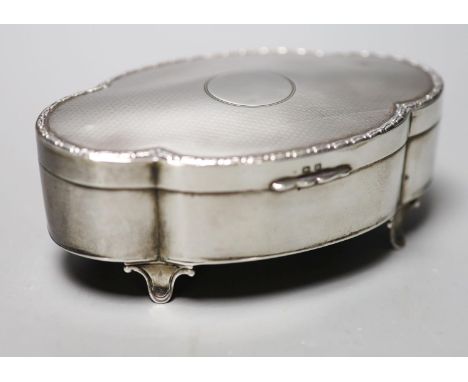 A George V part engine turned silver mounted shaped oval trinket box, Birmingham, 1911, 13.2cm.