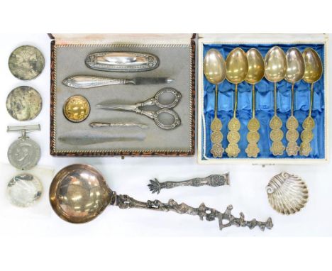 A DECORATIVE CONTINENTAL SILVER COLOURED METAL LADLE, A SILVER MANICURE SET, BOXED, INCOMPLETE, A SET OF SOUTH EAST ASIAN SIL