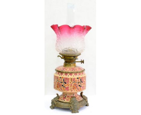 A BRASS MOUNTED HUNGARIAN EARTHENWARE OIL LAMP AND DETACHABLE FOUNT IN ZSOLNAY STYLE, WITH BRASS BURNER AND A CRANBERRY TINTE