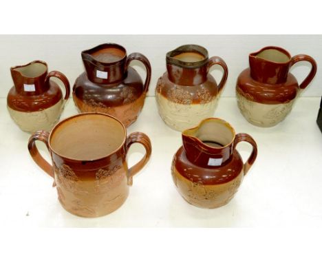 A 19TH C SALTGLAZED BROWN STONEWARE LOVING CUP AND SIX DOULTON AND OTHER HUNTING JUGS, ONE WITH SHEFFIELD PLATE RIM, VARIOUS 