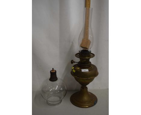 A brass oil lamp and shade