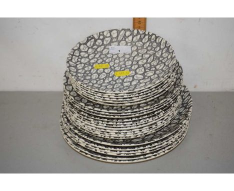 A quantity of Poole Pottery plates in the Black Pebble pattern, largest 25cm