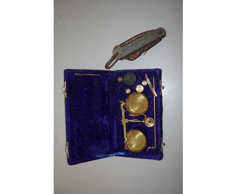 A velvet lined box containing a quantity of small weights and a scale together with a large penknife