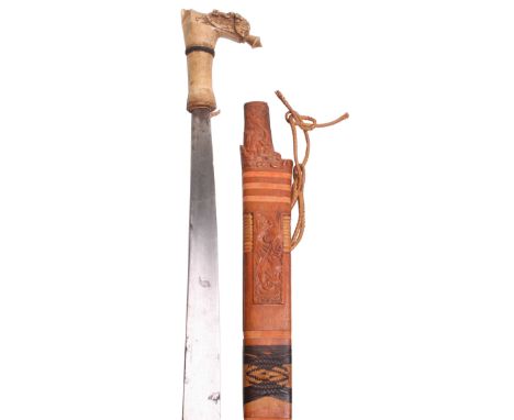 A 19th Century Borneo Head Hunter’s Sword Mandau, single edge blade, bone hilt carved with stylised heads, scrolls and animal