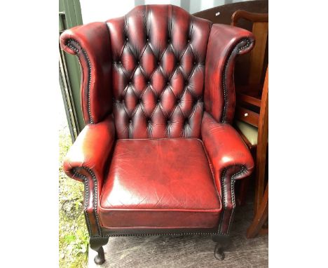 Geo. III style red leather upholstered armchair, with shaped button back and loose seat cushion on cabriole legs 