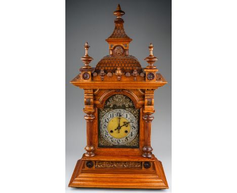 A Continental mantle clock, with 8 day movement and coiled gong, in Architectural style walnut case with column supports appr