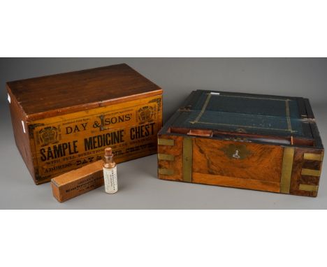 A late Victorian brass bound slopefront writing box, with brass strapwork and cartouche to cover, opens to reveal navy tooled