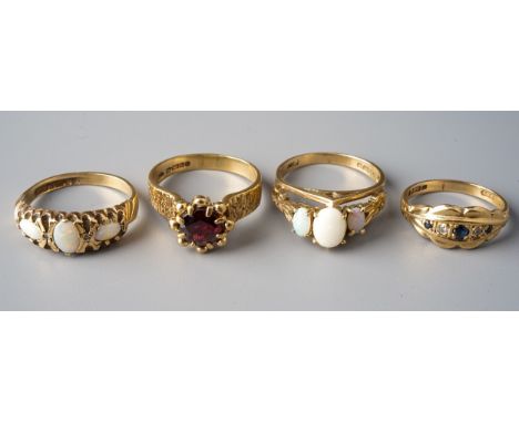 A 9ct yellow gold and garnet ring, size N; two 9ct yellow gold and opal rings, sizes M and M1/2; and a 9ct yellow gold sapphi