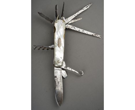 A tin containing a small collection of pocket knives and cut throat razors, including a hallmarked silver cased pen knife, Sh