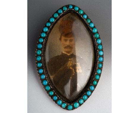 A 19th century navette memorial pendant, set with a photographic portrait of a military gentleman, within a turquoise beaded 