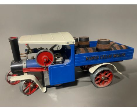 A vintage Mamod Steam Wagon SW1 in blue and red livery, with wooden barrels 