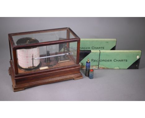 A vintage barograph in glazed oak case, 32 cm wide, to/w two boxes of spare charts and a bottle of ink 