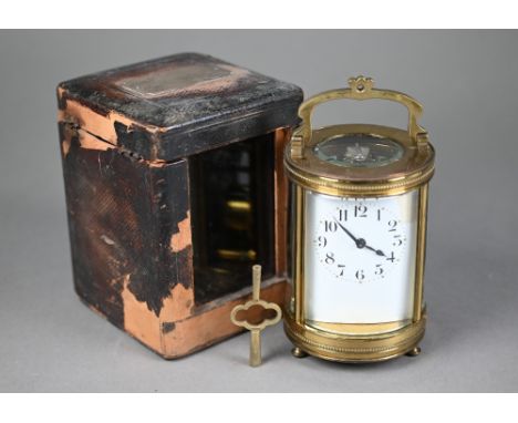 A 19th century French brass cylinder cased carriage clock, the single drum movement no. 4680 with gilt mask centred by a porc