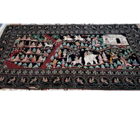 A late 19th century Burmese black felt textile Kalaga, applied with cotton and felt animals and figures in various pursuits w