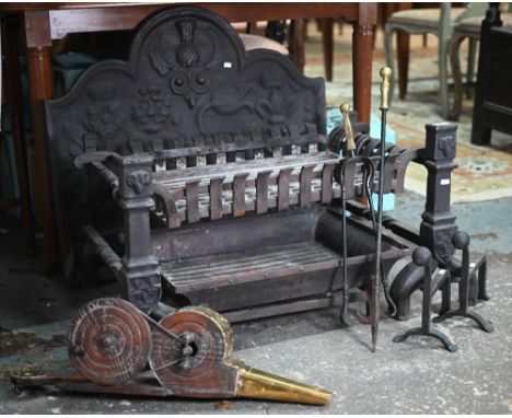 A substantial 17th century style cast iron fire back to/w conforming fire dogs and grate, wooden bellows, irons etc, overall 