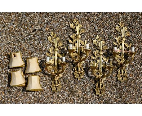 A set of four ormolu twin branch wall&nbsp; sconces/light fittings, with oakleaf, sword and ribbon bow design and cornucopia 