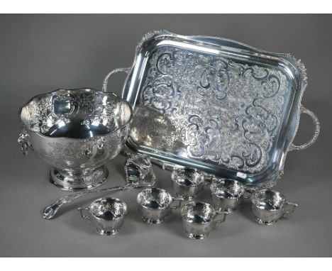 An electroplated punch bowl with floral and foliate embossed and engraved decoration, on raised foot, with six matching cups,