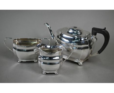 A silver three-piece tea service in the Regency manner with composite handle, on bun feet, Roberts &amp; Dore Ltd., Sheffield