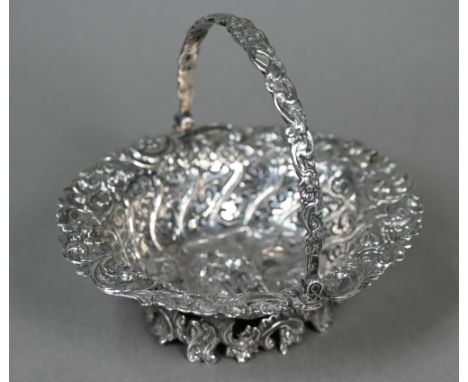 A Victorian silver bonbon basket, embossed with a rustic courting couple, in decorative pierced surround with swing handle, L