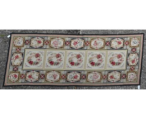 A traditional Aubusson needlepoint panel, the tile design with floral motifs, 220 cm x 89 cm 