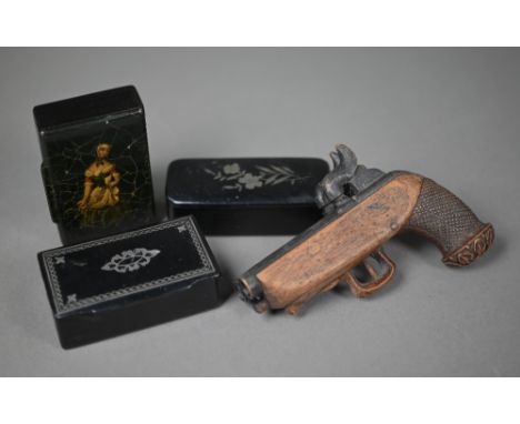 An antique novelty carved wood snuff box in the form of a double-barrelled pistol, to/w three papier mache snuff boxes - one 