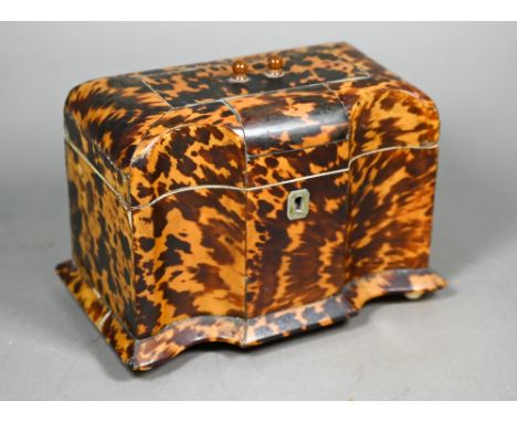 A Victorian serpentine-front tortoiseshell tea caddy with two inner lidded compartments, on ivory ball feet, 14 cm high x 19 