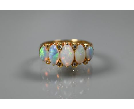 An antique opal and diamond ring, the five oval opals with rose cut diamonds between, gold set (unmarked), size N 
