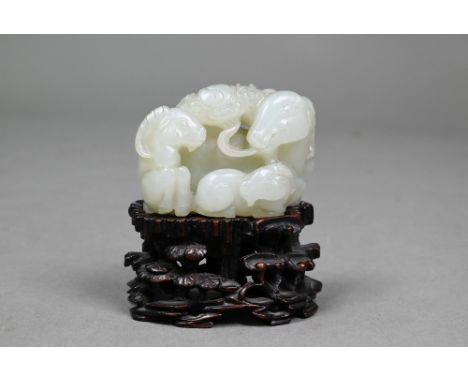 An 18th century Chinese jade carving of three rams, sanying, Qianlong period, Qing dynasty, the largest ram holding a spray o