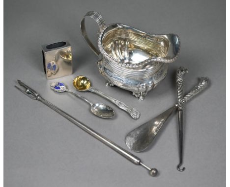 A Regency silver milk jug with egg and dart rim, scroll handle and reeded and engraved decoration, on scroll and hoof feet, m