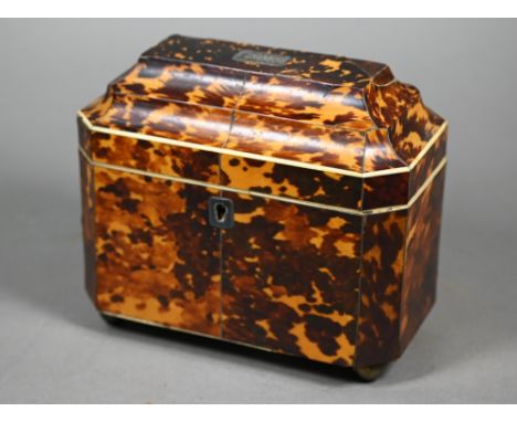 A Regency tortoiseshell sarcophagus tea caddy with moulded top enclosing two lidded compartments, on brass ball feet, 14.5 x 