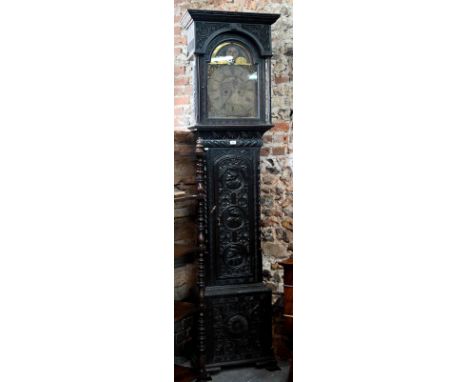 J Newton, Hexham, an 18th century profusely carved and moulded oak longcase clock, the 8-day movement with arched brass dial 