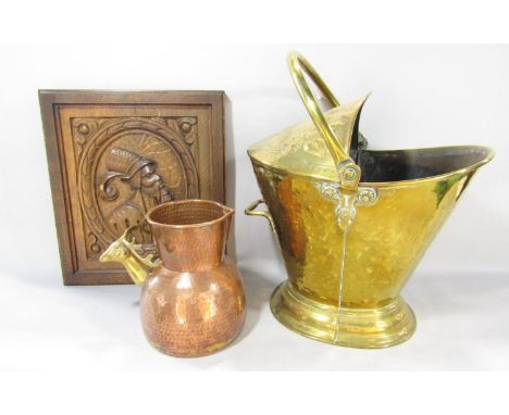 A 19th century brass coal helmet with a decorative floral embossed cover, a copper hammer finished jug with a brass reindeer 