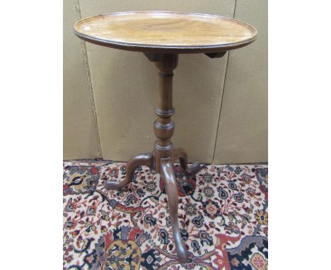 A Georgian mahogany occasional table, the dished top raised on a turned pillar and tripod base, 45 cm diameter 