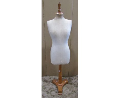 A Stockman of Paris mannequin raise on a timber base 