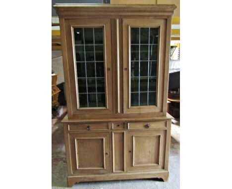 A substantial 19th century light oak two sectional dresser enclosed by an arrangement of cupboards and drawers, the upper wit