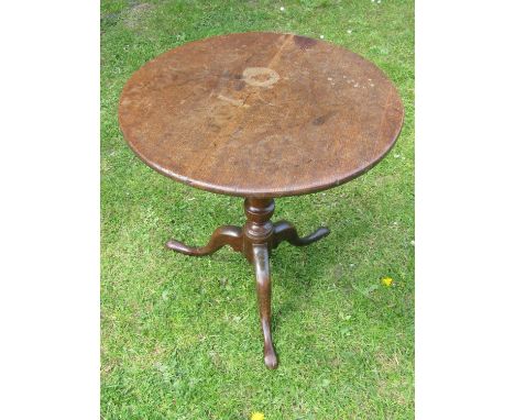 A Georgian oak country made snaptop occasional table on a vase shaped pillar and tripod base, 61 cm in diameter 