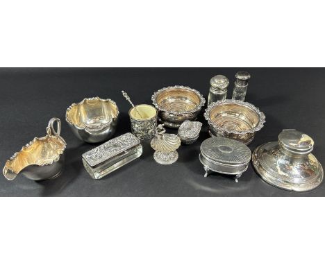 An assortment of silver hallmarked and sterling silver items including trinket boxes, a scallop salt dish, an inkwell, a must