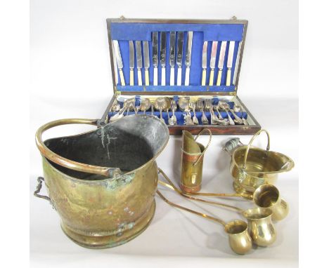 A brass coal bucket, three brass toddy ladles, rum, brandy and whisky, two miniature coal buckets a set of three brass fire t