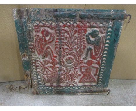 A carved hardwood panel of age with painted detail showing two monkey's dancing characters, etc and early iron hinges, 38 cm 