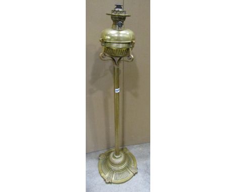 A late 19th century brass oil lamp standard with decorated base 