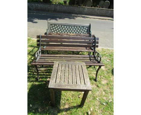 A two seat garden bench with weathered wooden slatted seat, cast lattice panelled back and scrolled end supports, 125 cm wide