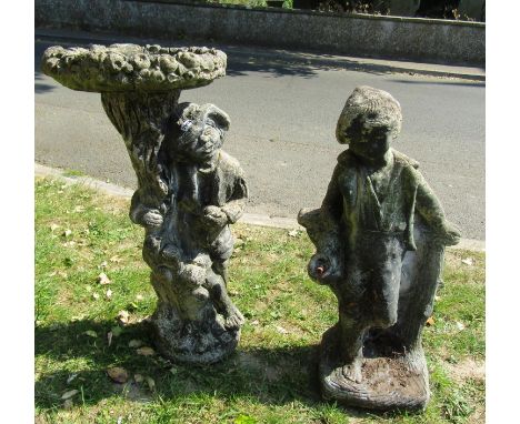 A weathered cast composition stone two sectional bird bath, the pedestal in the form of a man beside a tree trunk supporting 