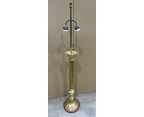 A brass table lamp the circular reeded column supporting a twin bulb fixture, 100cm high 