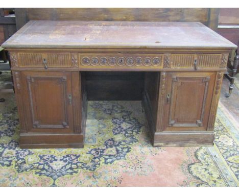 A late 19th century pale mahogany pedestal writing desk, each pedestal fitted with three deep drawers, the platform with thre