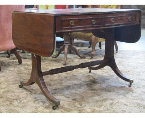 A Georgian mahogany sofa table of usual form with two real and two dummy drawers, raised on a stretcher base with swept suppo