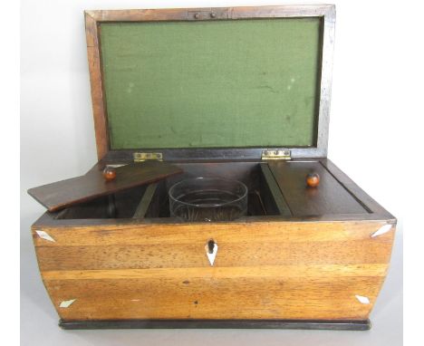 A Georgian mahogany sarcophagus shaped tea caddy, with a substitute mixing bowl, in need of restoration. 