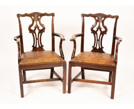 A pair of Chippendale style mahogany armchairs with shaped and carved cresting rails, pierced interlaced upright splats and s