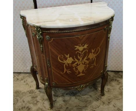 A French Demi-Lune side cupboard, the bowfronted outline incorporating a floral marquetry panel, set beneath a polished marbl