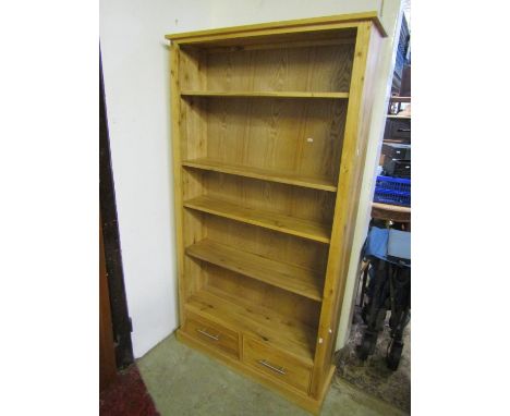A contemporary light oak floorstanding open bookcase with four adjustable shelves over two drawers 95 cm wide x 28 cm deep x 