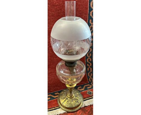 An early 20th century brass oil lamp with Art Nouveau patterns, with a clear cut glass font and Best Duplex wick adjusters, 6